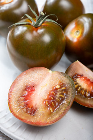 Fresh ripe sweet reddish brown and green kumato tomatoes close upの写真素材