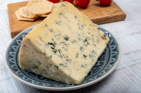 Cheese collection, English cow milk semi-soft, crumbly old stilton blue cheese close upの写真素材