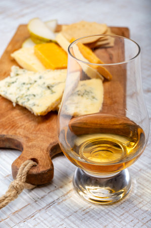 Scotch whiskey and cheese pairing, British cheeses collection, Blue stilton and Scottish colored and English matured cheddar cheeses, tasting tour in Englandの写真素材