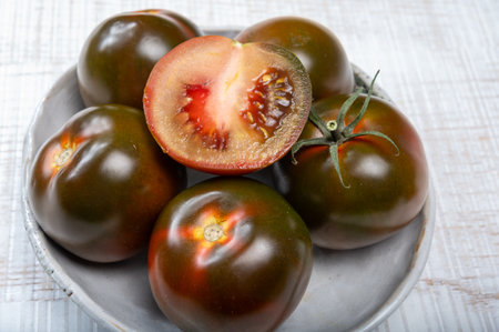 Fresh ripe sweet reddish brown and green kumato tomatoes close upの写真素材