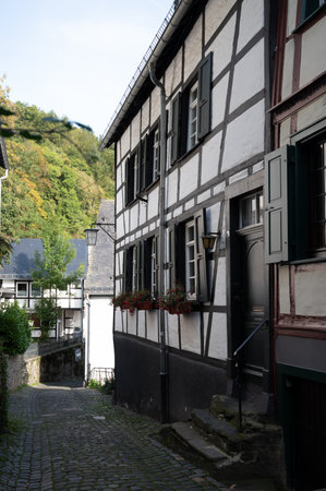 View of houses and streets of old colorful German town Monschau in bend of the river and hidden between the hills, Eifel national park, Germany in summerのeditorial素材