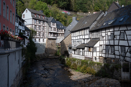 View of houses and streets of old colorful German town Monschau in bend of the river and hidden between the hills, Eifel national park, Germany in summerのeditorial素材