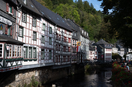 View of houses and streets of old colorful German town Monschau in bend of the river and hidden between the hills, Eifel national park, Germany in summerのeditorial素材