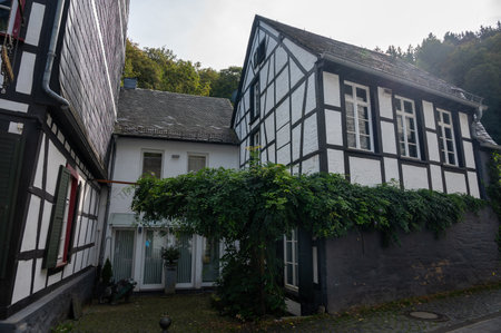 View of houses and streets of old colorful German town Monschau in bend of the river and hidden between the hills, Eifel national park, Germany in summerのeditorial素材