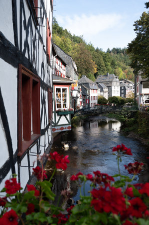 View of houses and streets of old colorful German town Monschau in bend of the river and hidden between the hills, Eifel national park, Germany in summerのeditorial素材