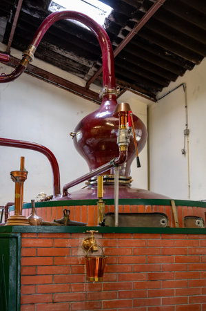 Double distillation process of cognac spirit in Charentias copper still pots and boilers in old distillery in Cognac white wine region, Charente, Segonzac, Grand Champagne, Franceのeditorial素材