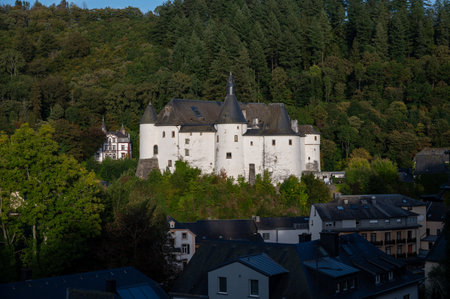 Views of Clervaux commune with town status in northern Luxembourg and green forest, capital of canton of Clervaux, white castle on sunsetのeditorial素材