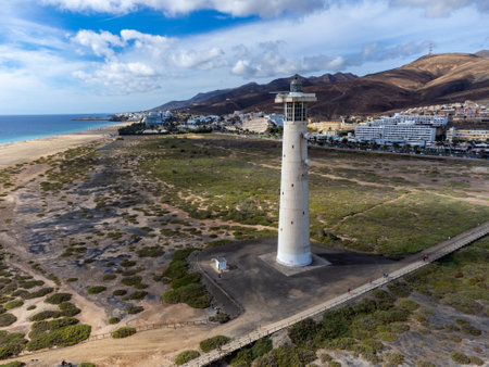 White sandy beach and blue ocean water in Morro Jable vacation village on south of Fuerteventura, Canary islands, Spain in winterの写真素材