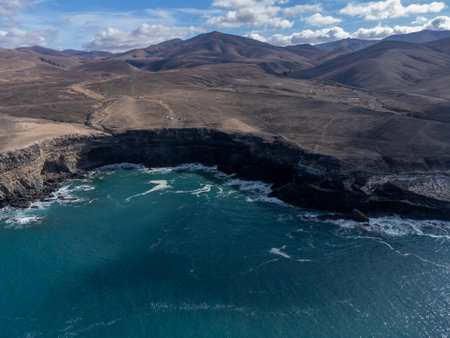 West coast of Fuerteventura island. View on blue water and black volcanic caves of Ajuy village, Canary islands, Spain.の写真素材