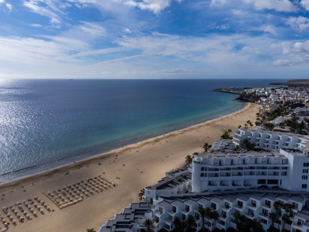 White sandy beach and blue ocean water in Morro Jable vacation village on south of Fuerteventura, Canary islands, Spain in winterの写真素材