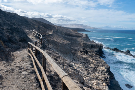 West coast of Fuerteventura island. View on blue water and black volcanic caves of Ajuy village, Canary islands, Spain.の写真素材