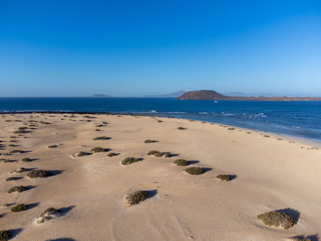 Aerial view Corralejo dunes, white sandy beach, blue water, Lobos and Lanzarote islands, north of Fuerteventura, Canary islands, Spainの写真素材