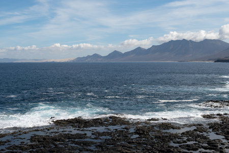 View from south on difficult to access golden sandy long Cofete beach hidden behind mountain range on Fuerteventura, Canary islands, Spainの写真素材