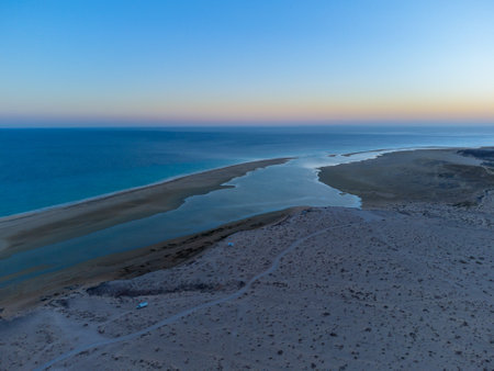 Aerial view on sandy dunes and turquoise water of Sotavento beach on sunset, Costa Calma, Fuerteventura, Canary islands, Spain in winterの写真素材