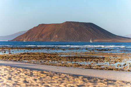 View Corralejo dunes, white sandy beach, blue water, Lobos and Lanzarote islands, north of Fuerteventura, Canary islands, Spainの写真素材