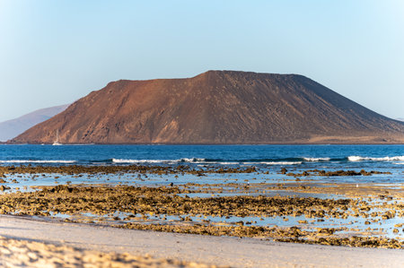 View Corralejo dunes, white sandy beach, blue water, Lobos and Lanzarote islands, north of Fuerteventura, Canary islands, Spainの写真素材