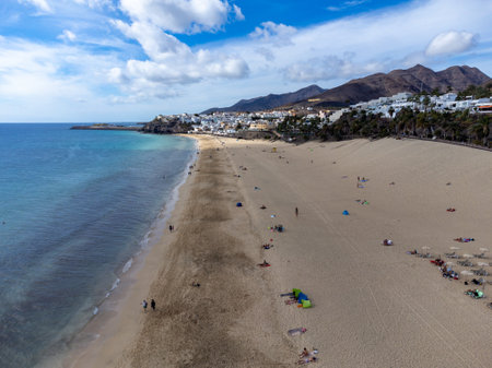 White sandy beach and blue ocean water in Morro Jable vacation village on south of Fuerteventura, Canary islands, Spain in winterのeditorial素材