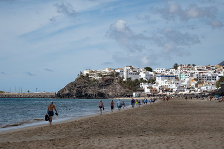 White sandy beach and blue ocean water in Morro Jable vacation village on south of Fuerteventura, Canary islands, Spain in winterのeditorial素材