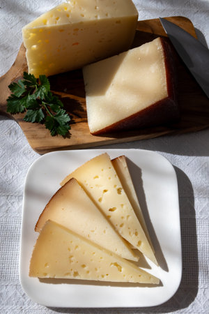 Spanish hard manchego, cow, sheep and goat cheese close upの写真素材