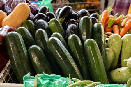 Fresh ripe green zucchini, carrots, tropical fruits and vegetables on farmers market on Fuerteventura, Canary islands, Spainの写真素材