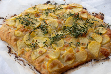 Fresh baked focaccia, pala romana pizza with potato vegetables and rosemary in bakery in Parma, Emilia Romania, Italyの写真素材