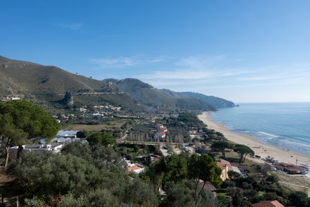 View on sandy beach from hilly medieval small touristic coastal town Sperlonga and sea shore, Latina, Italy in winterの写真素材