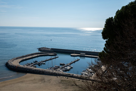 View on empty yachts harbor from hilly medieval small touristic coastal town Sperlonga and sea shore, Latina, Italy in winterの写真素材