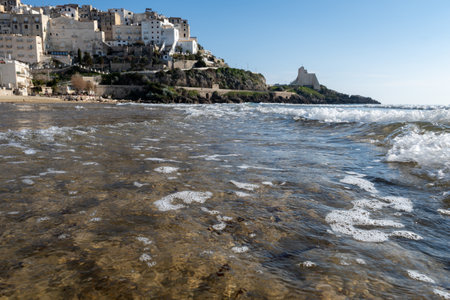 View on sandy beach and sea water in medieval small touristic coastal town Sperlonga and sea shore, Latina, Italy in winterの写真素材