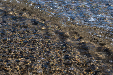 Crystal clear sea water texture with glare from the sun, wallpaper, nature backgroundの写真素材