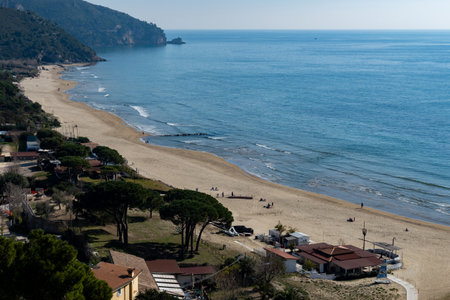 View on sandy beach from hilly medieval small touristic coastal town Sperlonga and sea shore, Latina, Italy in winterの写真素材