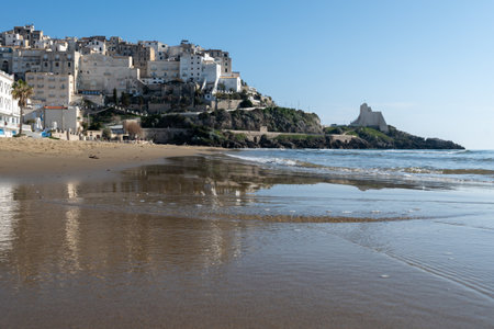 View on sandy beach and sea water in medieval small touristic coastal town Sperlonga and sea shore, Latina, Italy in winterの写真素材