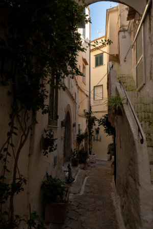 White old houses and narrow streets in medieval small touristic coastal town Sperlonga, Latina, vacation in Italy, winterの写真素材