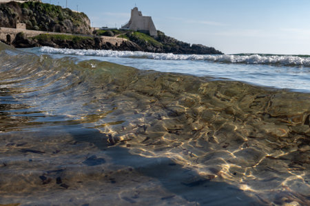 View on sandy beach and sea water in medieval small touristic coastal town Sperlonga and sea shore, Latina, Italy in winterの写真素材