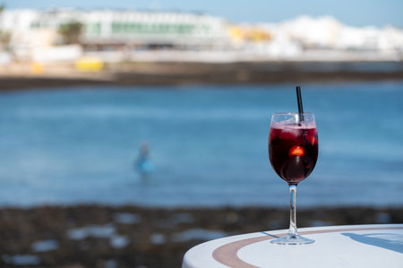 Glass of cold sangria sweet wine served with orange in beach cafe, Corralejo, Fuerteventura, Spainの写真素材