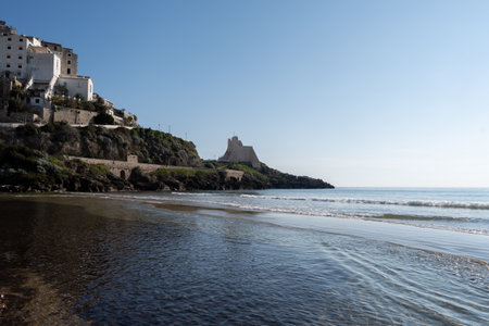 View on sandy beach from hilly medieval small touristic coastal town Sperlonga and sea shore, Latina, Italy in winterの写真素材