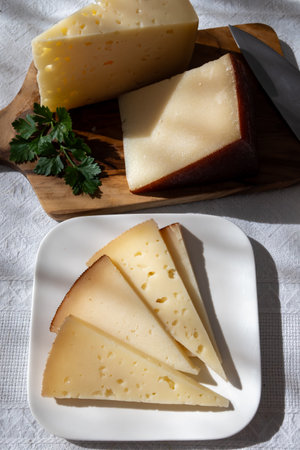 Spanish hard manchego, cow, sheep and goat cheese close upの写真素材