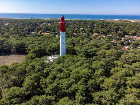 Aerial view on Arcachon Bay with many fisherman's boats and oysters farms, forest and red lighthouse Le Phare du Cap Ferret, Cap Ferret peninsula, France, southwest of Bordeaux, France's Atlantic coastlineの写真素材