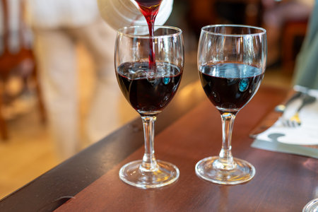 Red dry wine in glasses, lunch with wine in France, old bistro in Limouges, Franceの写真素材