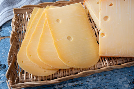 Cheese collection, Dutch ripe hard cheese made from cow milk in the Netherlands in piece and sliced close upの写真素材