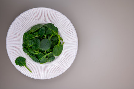 Fresh green baby Spinach leaves, diet and health concept, weight loss, washed spinach on ceramic...