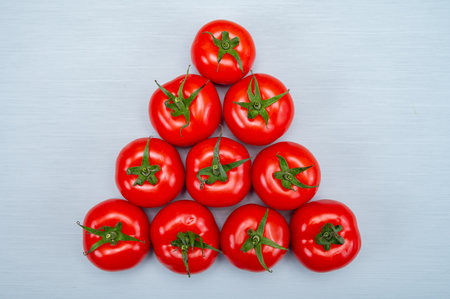 Food triangle, fresh Red ripe tasty Dutch tomatoes, vegetables background top view close up copy...