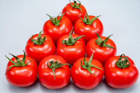 Food triangle, fresh Red ripe tasty Dutch tomatoes, vegetables background top view close up copy spaceの写真素材