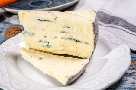 Piece of french goat cheese with black summer truffles mushrooms close upの写真素材