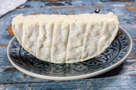 French soft Camembert cheese, original Camembert de Normandie, piece, close up with white moldの写真素材