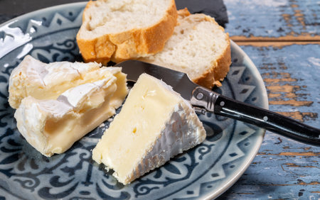 French soft Camembert cheese, original Camembert de Normandie, piece, close up with white moldの写真素材