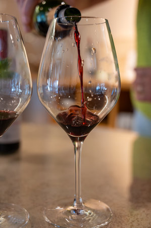 Tasting of red dry Saint-Emilion wine aged in French oak wooden barrels in cellar, Saint-Emilion great wines making region, France, Bordeaux made from Merlot, Cabernet Sauvignon red wine grapesの写真素材