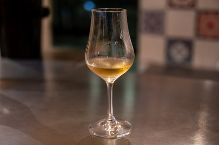 Tasting of cognac spirit aged in old dark French oak barrels in cellar in distillery house, Cognac white wine region, Charente, Segonzac, Grand Champagne, Franceの写真素材