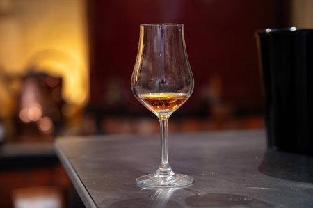 Tasting of cognac spirit aged in old dark French oak barrels in cellar in distillery house, Cognac white wine region, Charente, Segonzac, Grand Champagne, Franceの写真素材