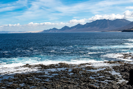 View from south on difficult to access golden sandy long Cofete beach hidden behind mountain range on Fuerteventura, Canary islands, Spainの写真素材