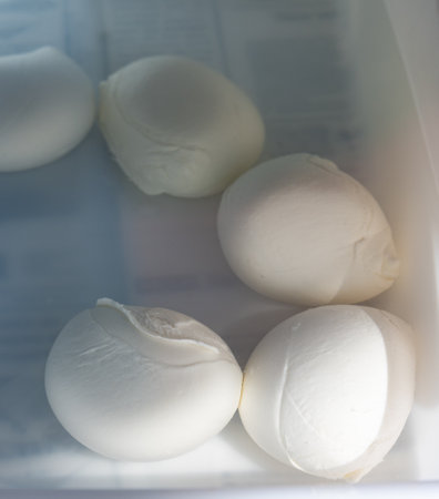 Tasty Italian food, small balls of white mozzarella soft cheese on farm in boxの写真素材
